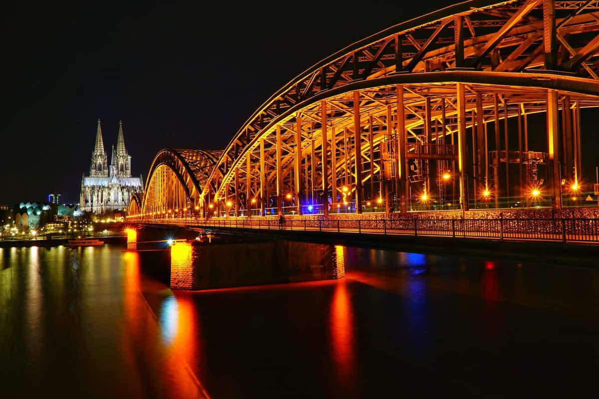 lighted bridge and view of church at nighttime