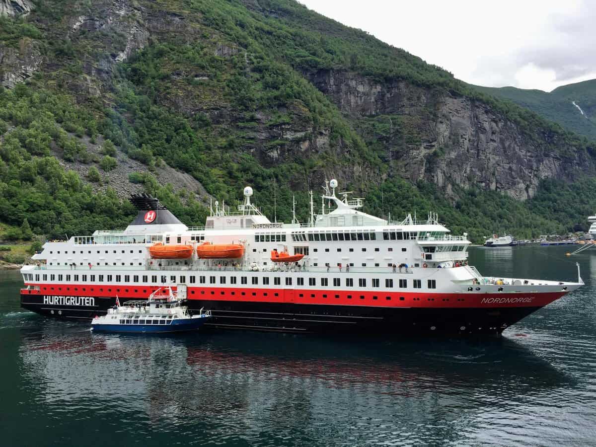 nordnorge passenger ship on the sea near a mountain